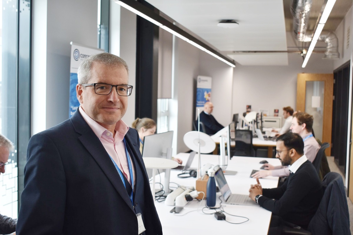 Managing Director David Watson standing in front of the hard working Concentric team Concentric David Watson Team
