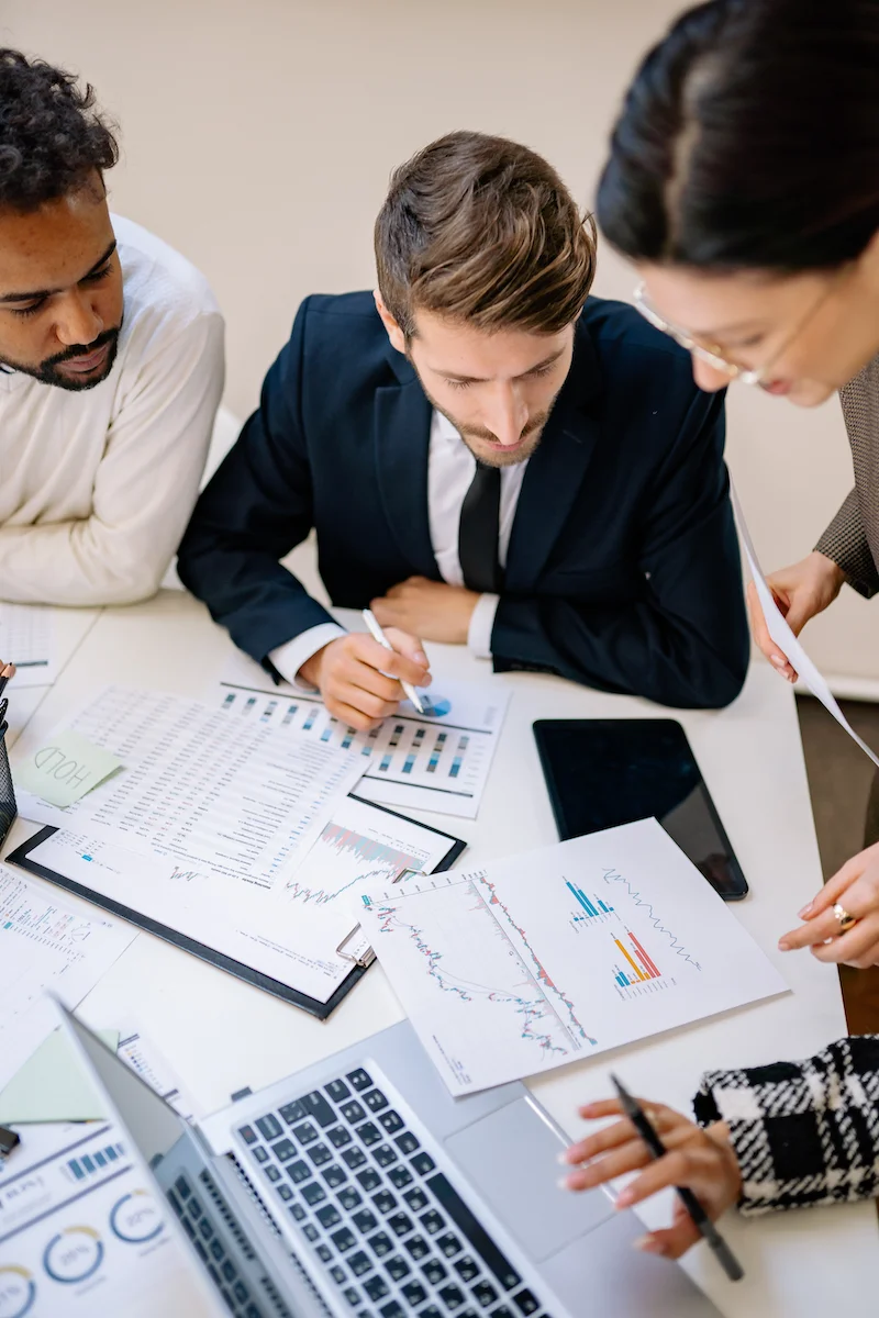 Finance Team discussing printed reports